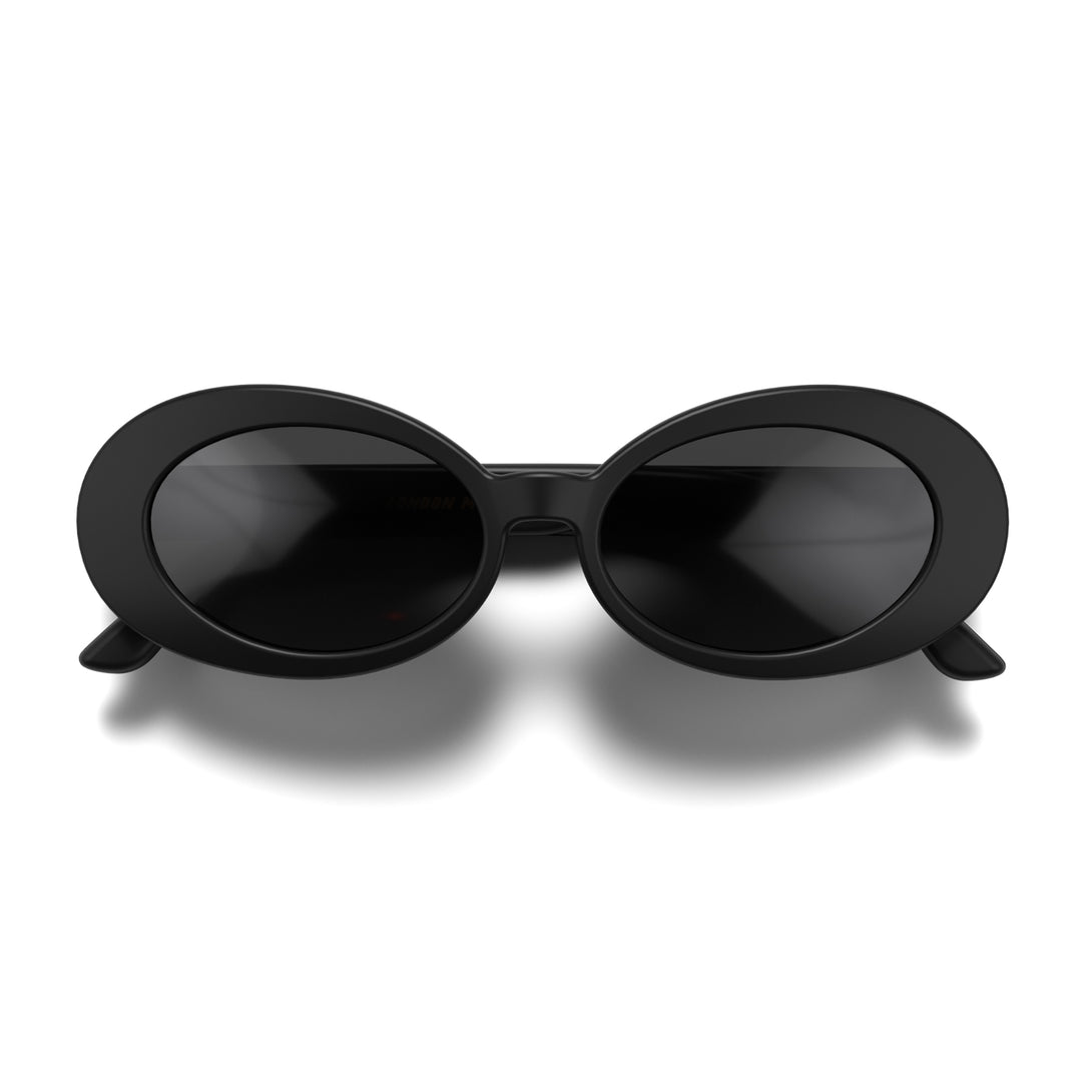 Front - Nifty sunglasses in matt black featuring a bold, vintage oval frame and black UV400 lenses. The perfect accessory.