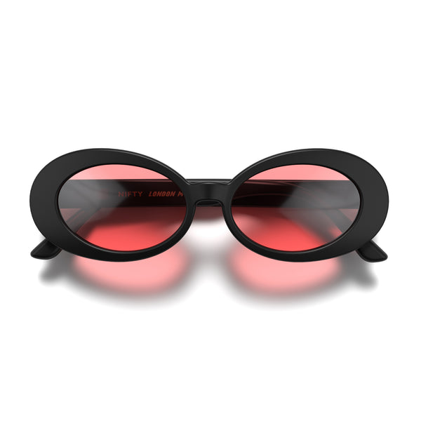Front - Nifty sunglasses in matt black featuring a bold, vintage oval frame and red UV400 lenses. The perfect accessory.
