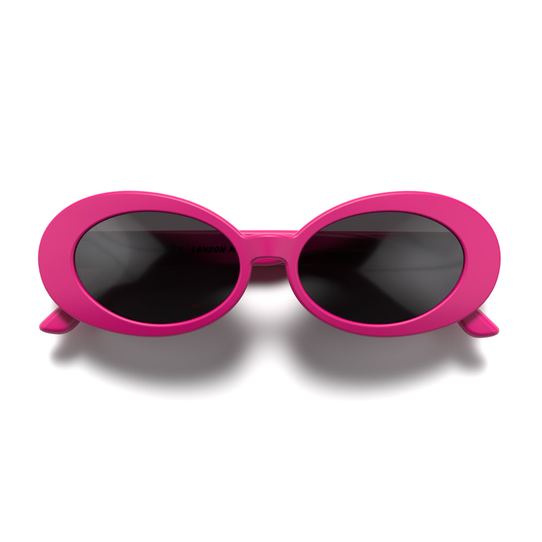 Front - Nifty sunglasses in matt pink featuring a bold, vintage oval frame and black UV400 lenses. The perfect accessory.