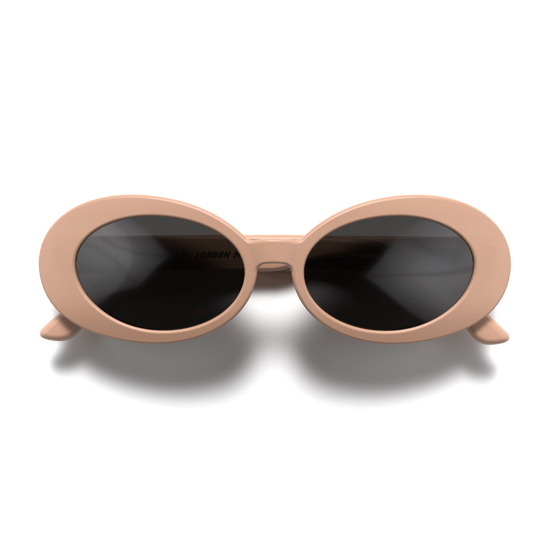 Front - Nifty sunglasses in soft pink featuring a bold, vintage oval frame and black UV400 lenses. The perfect accessory.