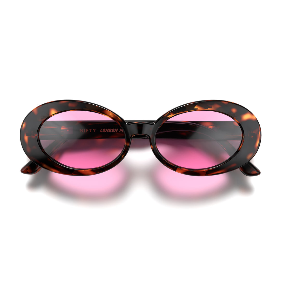 Front - Nifty sunglasses in gloss tortoiseshell featuring a bold, vintage oval frame and pink UV400 lenses. The perfect accessory.