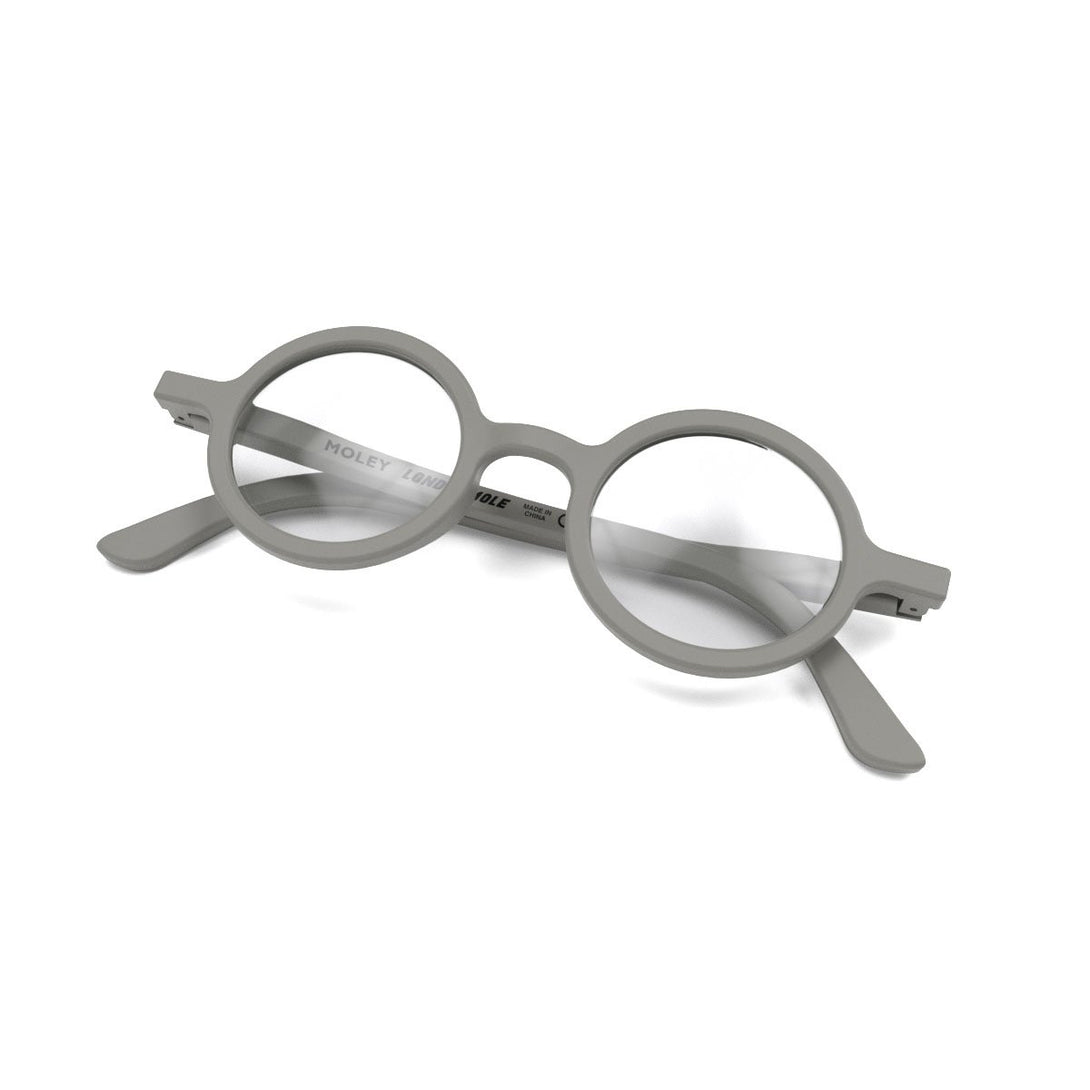 Skew Folded - Moley Reading Glasses in matt grey featuring an eccentrically round frame and provide crystal clear vision. Available in a + 1, 1.5, 2, 2.5, 3 prescriptions.