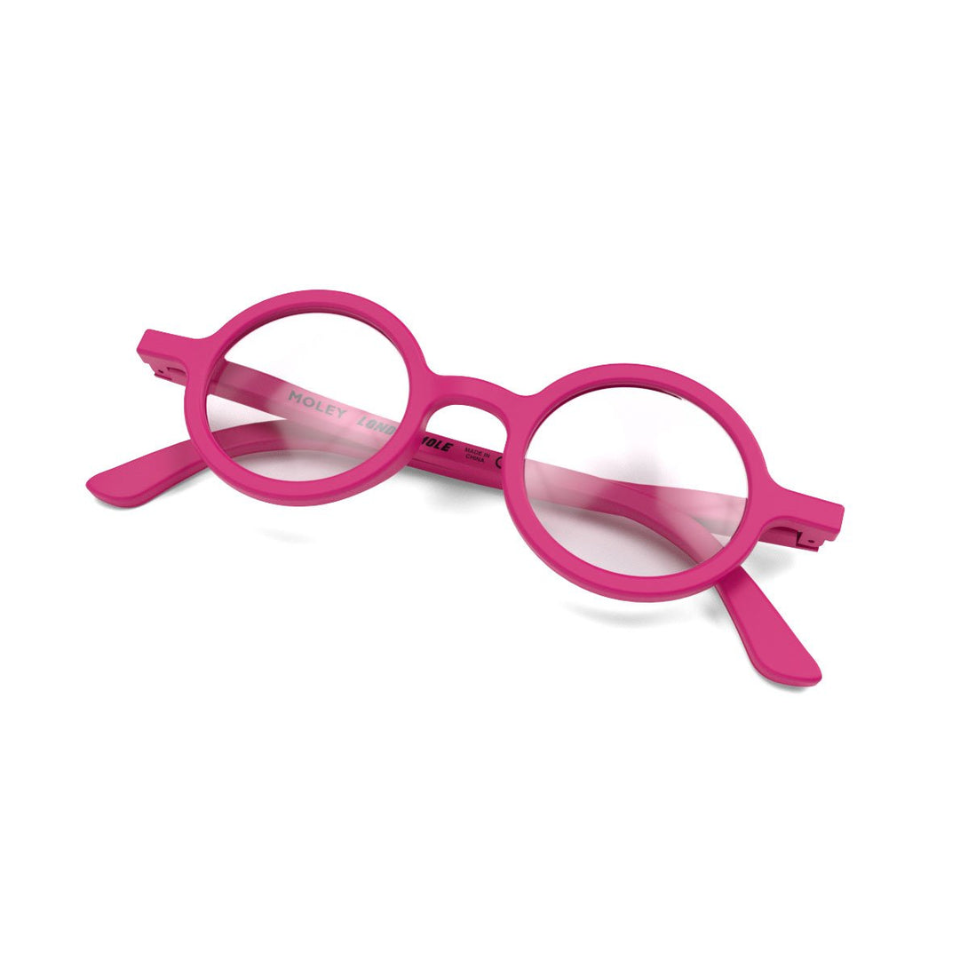 Skew folded - Moley Blue Blocker Glasses in matt pink featuring an eccentrically round frame and the ability to protect your eyes from artificial blue light. Ideal for fashion accessories, screen time, office work, gaming, scrolling on a mobile, and watching TV. 
