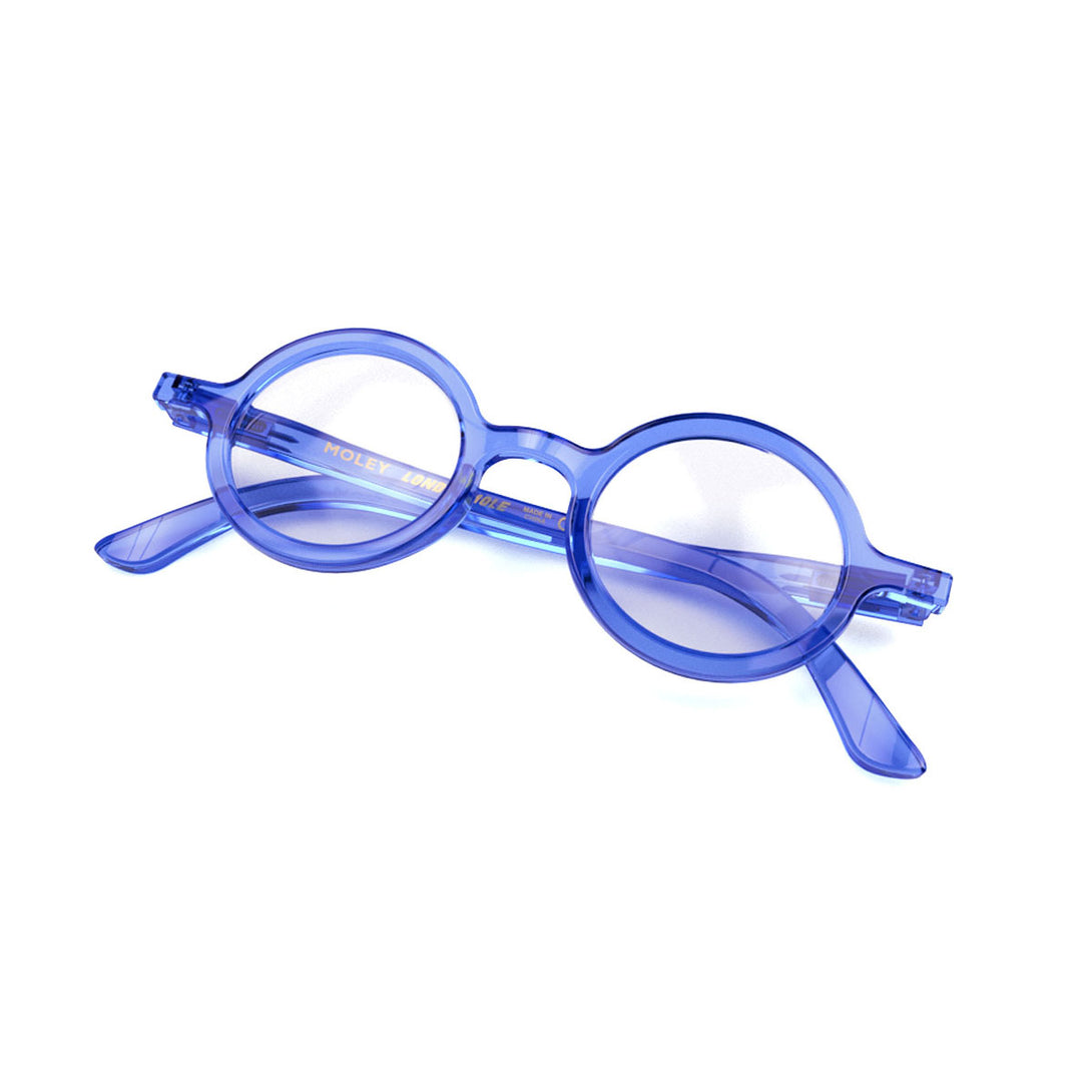 Folded skew - Moley Blue Blocker Glasses in transparent blue featuring an eccentrically round frame and the ability to protect your eyes from artificial blue light. Ideal for fashion accessories, screen time, office work, gaming, scrolling on a mobile, and watching TV. 