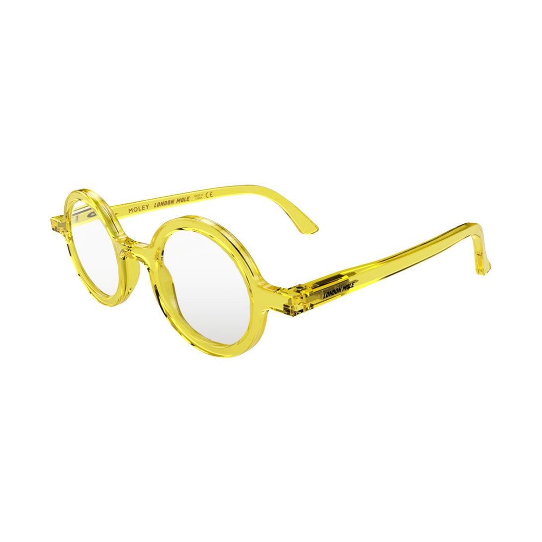 Open skew - Moley Reading Glasses in transparent yellow featuring an eccentrically round frame and provide crystal clear vision. Available in a + 1, 1.5, 2, 2.5, 3 prescriptions.