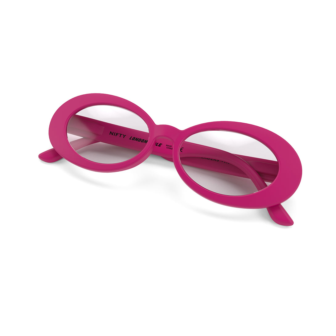 Folded skew - Nifty Blue Blocker Glasses in matt pink featuring a bold, vintage oval frame and the ability to protect your eyes from artificial blue light. Ideal for fashion accessories, screen time, office work, gaming, scrolling on a mobile, and watching TV. 